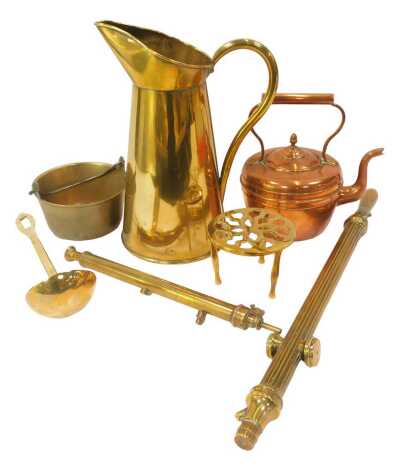 A group of copper and brass ware, to include a brass ewer, 37cm high, ladle, rose sprayers, brass preserve pan, trivet, and a copper kettle.