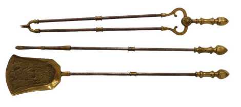 A late 19th/early 20thC brass and iron fireside implements, comprising tongs, shovel and poker.