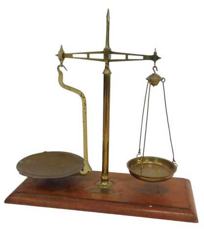 A set of oak and brass scales, bearing a plaque for The Cooperative Wholesale Society Limited Makers Baloon CT Manchester, 52cm high.