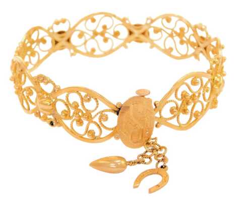 A Continental filigree design bracelet, the oval loops with pierced and scroll design, with shell capped centre, barrel clasp bearing the initials MS, unmarked, 6.5cm diameter, 23.9g.