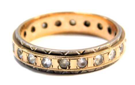 A 9ct gold eternity ring, set with czs, with bicolour outer border with cross hatching, ring size P, 3.3g all in.