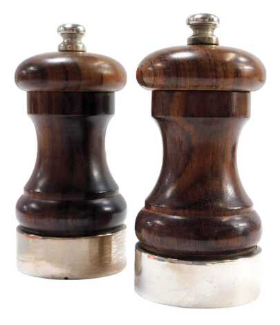 A pair of Elizabeth II wooden and silver salt and pepper mills, by maker MCH, London 2008, 12cm high.