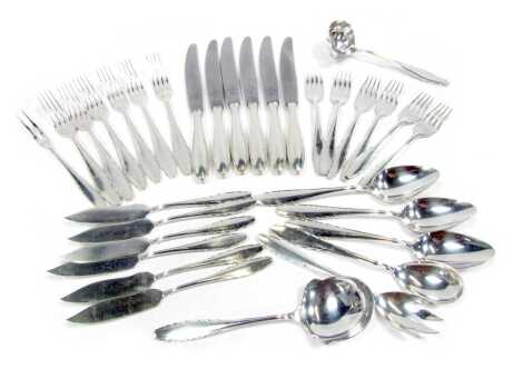 A 1920s WMF cutlery set, comprising six dinner knives and forks, six fish knives and forks, three serving spoons, salad, fruit and fish servers, sauce ladle, in pewter with cutlery display sleeve.