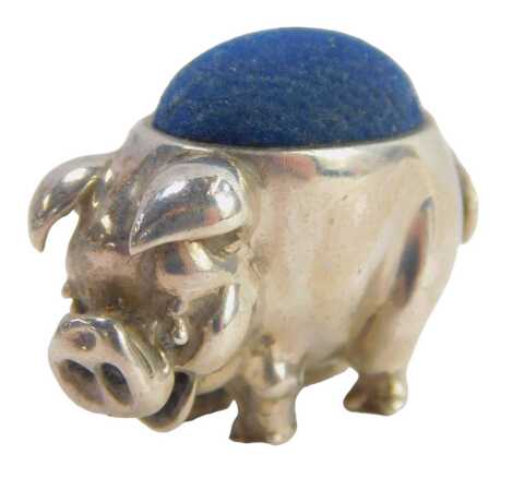 A miniature pig pin cushion, with blue cushion, on white metal stamped 925, 2cm high.