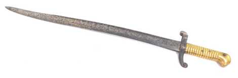 A 19thC French bayonet, engraved to tip of blade, with ribbed brass handle, the hilt numbered 1130, 69cm long.