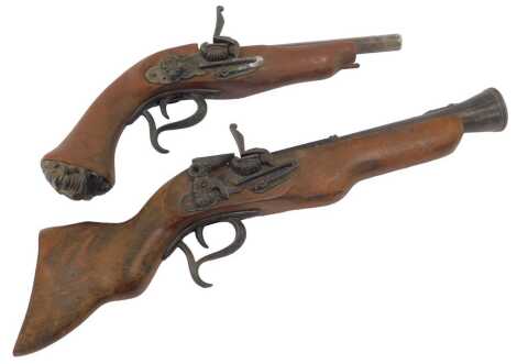 A reproduction Continental pistol, with wooden stock, 48.25cm long, and a reproduction flintlock pistol, with lion head pommel, 36cm long. (2)