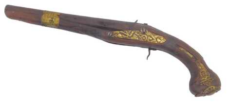 An Eastern flintlock pistol, possibly Turkish, wooden stock and brass decorative inlay, 39cm long. (AF)