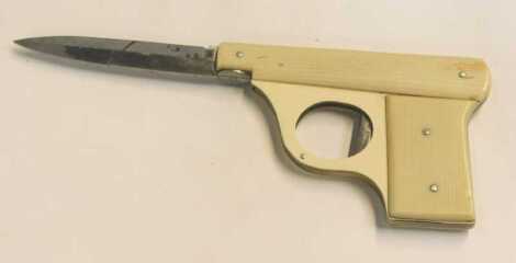 A mid century collector's knife in the form of a small pocket pistol, the cellulose body having steel rivets and the trigger enabling the blade release, 10cm closed.