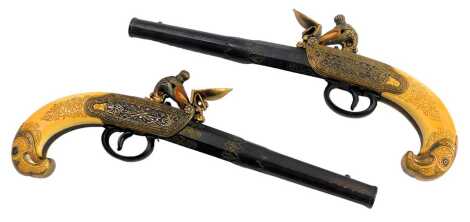 Two replica antique pistols, each in the 18thC style, with box and eagle shaped handle and cock, 28cm long. (2)