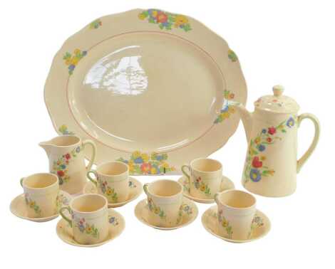 A Royal Doulton Hadley pattern tete-a-tete, comprising oval serving tray, coffee pot and lid, milk jug, six coffee cans and saucers.