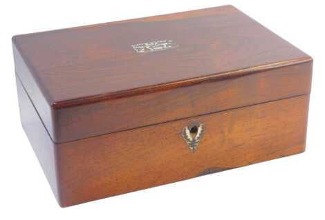 A Victorian rosewood workbox, with mother of pearl inlaid vase of flowers escutcheon opening to reveal a partially fitted and red baize lined interior, 12cm high, 29cm wide, 21cm deep.