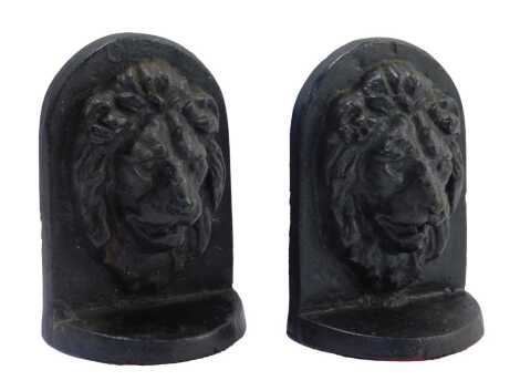 A pair of black painted cast iron lion bookends, 18cm high.