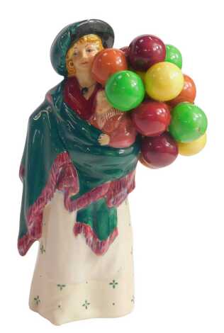 A Royal Doulton porcelain figure, modelled as The Balloon Seller, HN583.