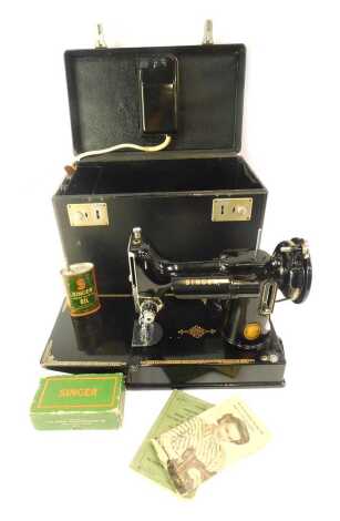 A Singer electric sewing machine, cased with accessories.WARNING! This lot contains untested or unsafe electrical items. It is supplied for scrap or re-conditioning only TRADE ONLY