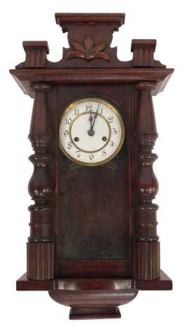 An early 20thC mahogany cased wall clock, the circular white enamel dial bearing Arabic numerals, eight day, 60cm high.