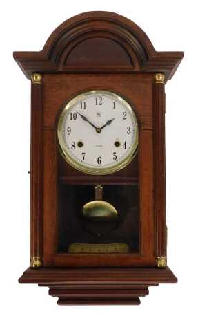 A 20thC mahogany cased wall clock, circular white dial bearing Arabic numerals, thirty one day, with key and pendulum, 56cm high.