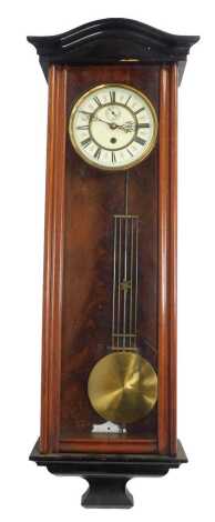 A mahogany and ebonised wall clock, the circular cream enamel dial bearing Roman numerals, subsidiary seconds, thirty hour, with pendulum, 87cm high.