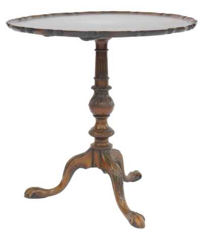 A late 19th/early 20thC mahogany tilt top table, circular piecrust top above a turned, fluted and carved column, on leaf carved legs with ball and claw feet, 60cm high, 62cm diameter.