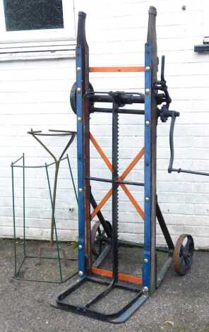 A Cooks Patent Yaxley Peterborough wind up sack barrow, a wirework stand and a metal planter. (3)