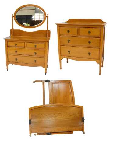 An Edwardian light oak bedroom suite, comprising a dressing chest, with an oval swing frame mirror, over two short above two long drawers, raised on turned legs, on castors, 60cm high, 107cm wide, 46cm deep, a chest of two short and two long drawers, 102c