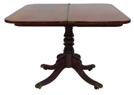 A George IV mahogany fold over tea table, raised on a turned column over four reeded cabriole legs, brass capped on castors, 72cm high, 93cm wide, 47cm deep.