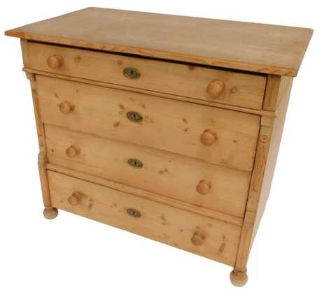 A Continental pine chest of four graduated drawers, with carved decoration to each end, on compressed cylindrical turned feet, 88cm high, 100cm wide, 58cm deep.