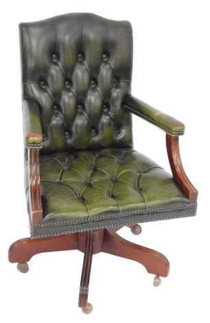 A 20thC green leather office chair, with button back and seat, overstuffed arms, stud work borders and four lion carved legs on castor. (AF) The upholstery in this lot does not comply with the 1988 (Fire & Fire Furnishing) Regulations, unless sold to a kn