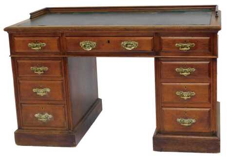 A late Victorian walnut pedestal desk, with raised back, green leatherette inset, the base with an arrangement of nine drawers, on plinth base, 76cm high, 121cm wide, 69cm deep.