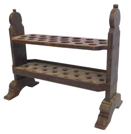 An 18thC pitch pine two tier candlemaker's rack, with shaped end supports, 64cm high, 56cm wide, 30cm deep. (AF)