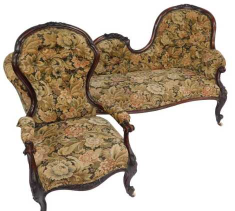 A Victorian mahogany show-frame chaise longue, with scrolling leaf carved back, floral upholstery, on scrolling carved legs with castors, 175cm wide, together with a spoonback matching armchair.