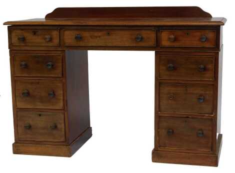 A 19thC mahogany pedestal desk or dressing table, the top with a moulded edge, with raised back above arrangement of seven drawers, on a plinth, 85cm high, 121cm wide, 46cm deep.