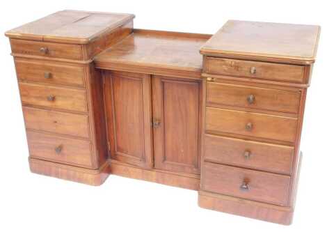 A 19thC mahogany inverted breakfront dressing table, each top section with a moulded edge with two central panelled doors enclosing three shelves flanked to one side by five drawers and the other with a hinged top enclosing a marble recess for a sink and 