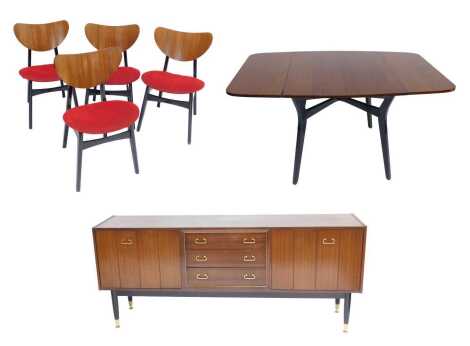 A mid century EG Gomme teak dining suite, comprising drop leaf table, on black painted tapering legs, 72cm high, 80cm wide, together with four dining chairs, and a sideboard, 82cm high, 189cm wide, 45cm deep. The upholstery in this lot does not comply wit