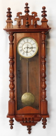 A 20thC walnut cased Vienna wall clock, with circular white enamel dial bearing Roman numerals, subsidiary seconds, eight day movement, 120cm high.