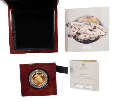 A Star Wars Millennium Falcon 2024 one quarter ounce gold proof coin, with original box and packaging.