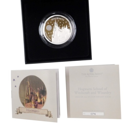 A Hogwarts School of Witchcraft and Wizardry 2023 UK two ounce silver proof coin, number 74, with box and packaging.