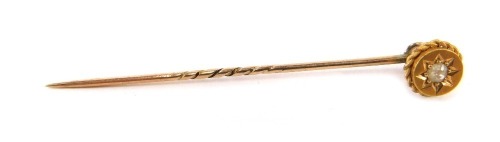 A stick pin, the top set with tiny diamond in star setting, on a gold rope twist head, yellow metal, unmarked, 5.5cm high, 1.7g all in.