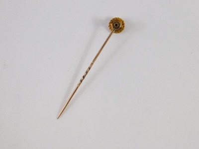 A stick pin, the top set with tiny diamond in star setting, on a gold rope twist head, yellow metal, unmarked, 5.5cm high, 1.7g all in. - 2