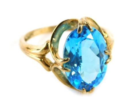 A QVC 9ct gold dress ring, the oval cut blue topaz claw set, with openwork ring head, ring size O, 3.6g all in.