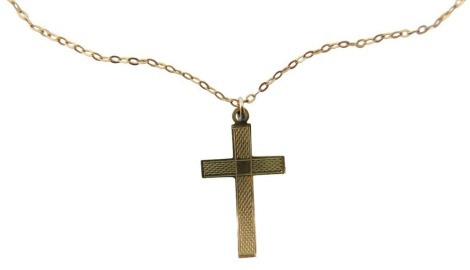 A 9ct gold crucifix pendant and chain, the crucifix with engine turned decoration, on a fine link neck chain, yellow metal marked 9ct, 42cm long, 1.9g.