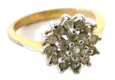 A cluster dress ring, set with layers of CZ stones, in white metal setting, unmarked.