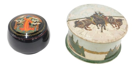 A Russian wooden box and cover, painted with a winter landscape, 19cm diameter, and a lacquered box. (2)