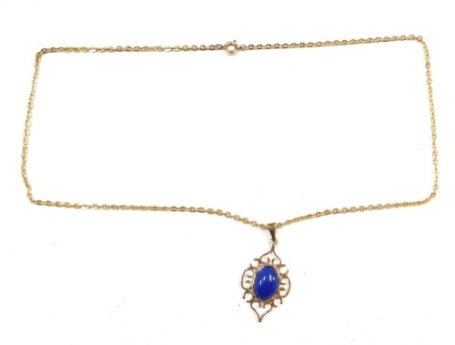 A 9ct gold lapis pendant and chain, the shaped pendant with oval lapis and pierced scroll outer border, on a fine link gold plated neck chain, the pendant 2.5cm high, 4.1g all in.