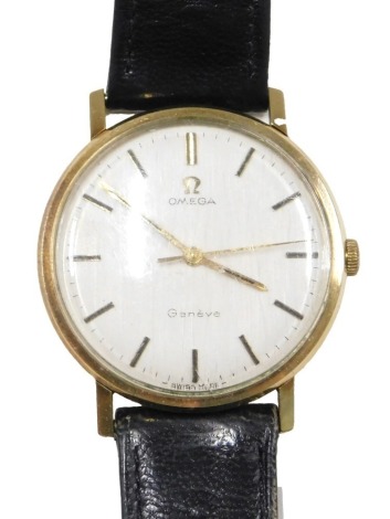 An Omega Constellation gent's wristwatch, on a silvered and baton dial with gold hands, yellow metal case unmarked, on black leather strap, the dial 3cm wide, 26.2g all in.