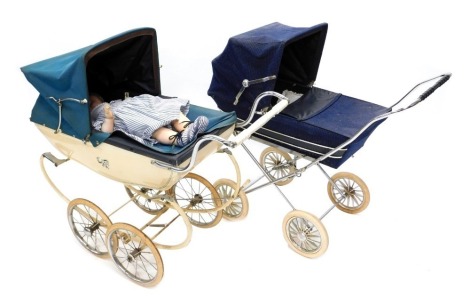 Two coach built child's prams, a silver cross pram with blue fabric sides, hood, and plastic spoked wheels, and another silver cross, with cream painted metal sides, green canvas hood and spoke wheels, and a late Armand Marseille 10.5" composition doll.