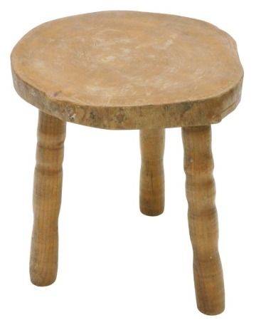 A rustic elm stool, with three turned legs, 42cm high, 39cm wide.