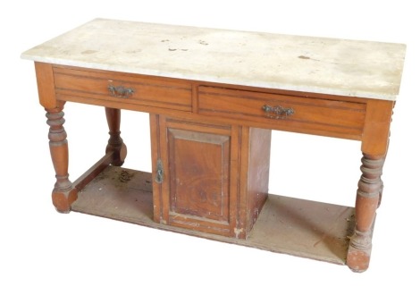 A late Victorian walnut washstand, white top, frieze drawers, and a door, on turned supports, 63cm high, 122cm wide. (AF)