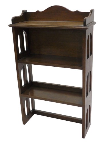 An early 20thC oak bookcase, with pierced sides, 97cm high, 61cm wide.