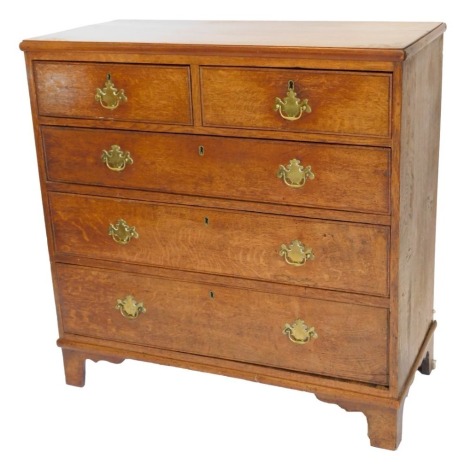 A early 19thC oak chest of drawers, the top with a moulded edge above two short and three long drawers, with brass handles on bracket feet, 96cm high, 97cm wide.