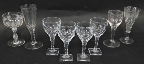 A collection of 19thC and later glasses, to include an engraved wine glass with tapering bowl and faceted stem, another wine glass with fluted bowl, and a set of four glasses each with a faceted stem and square base. We have specific vendors instructions